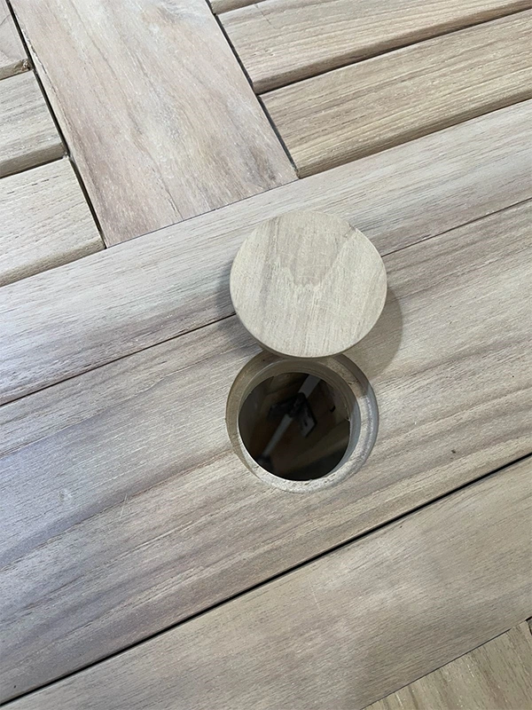 Quality inspection of solid teak dining table at Jepara factory